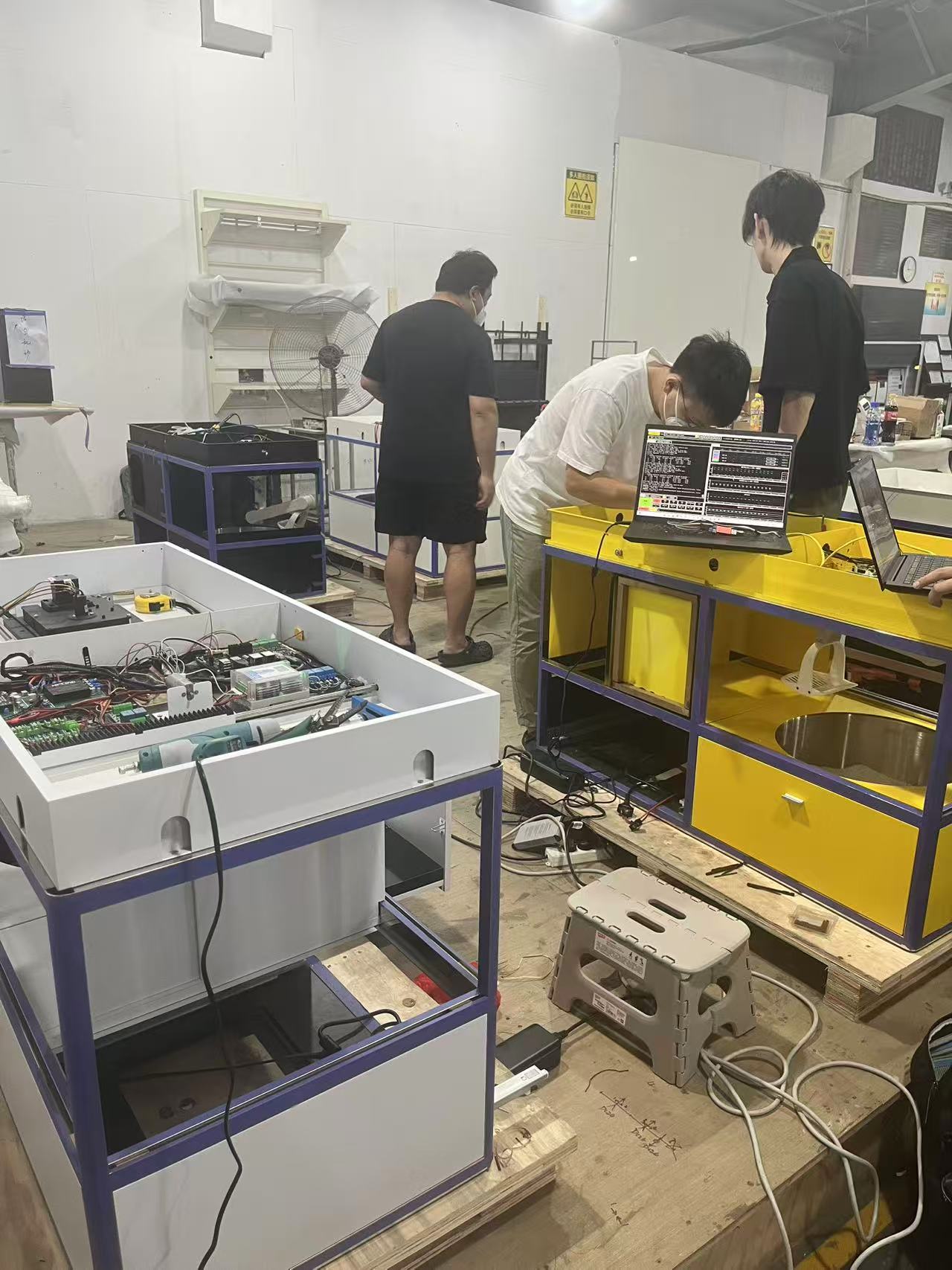 Team debugging multiple prototype units in the workshop